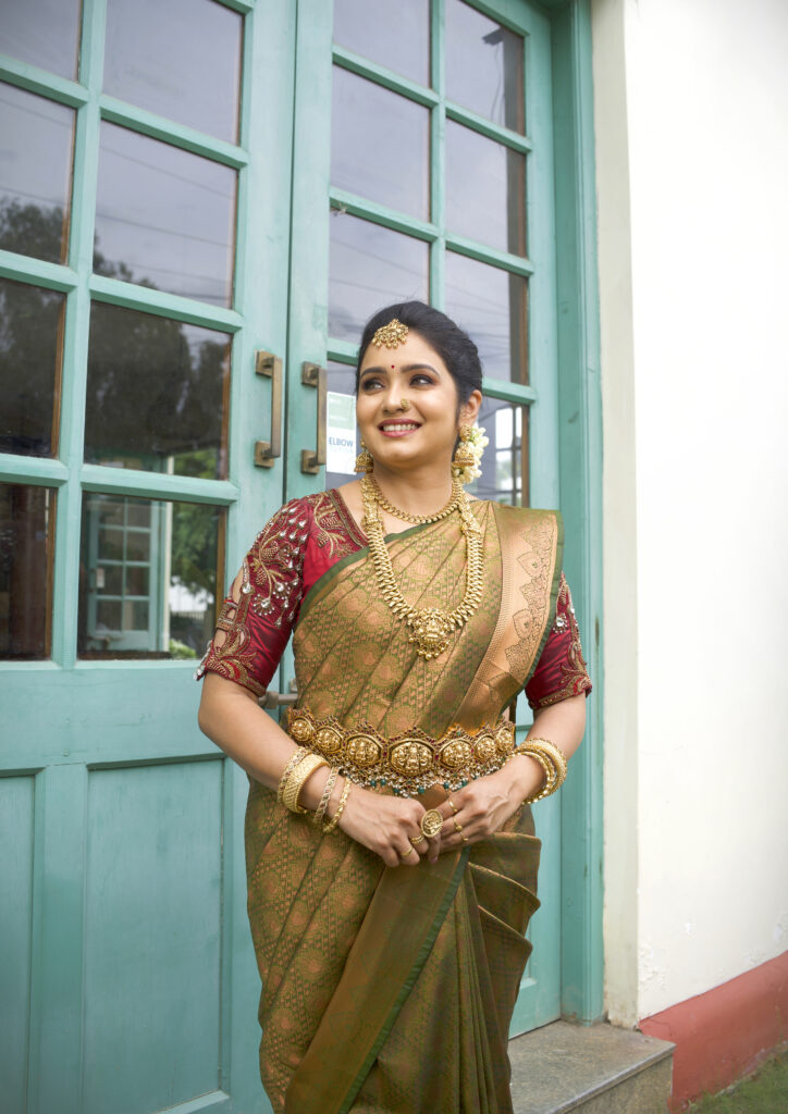 Bride with floral hairdo and gold jewelry, makeup by Lara Styles Unisex Salon Coimbatore