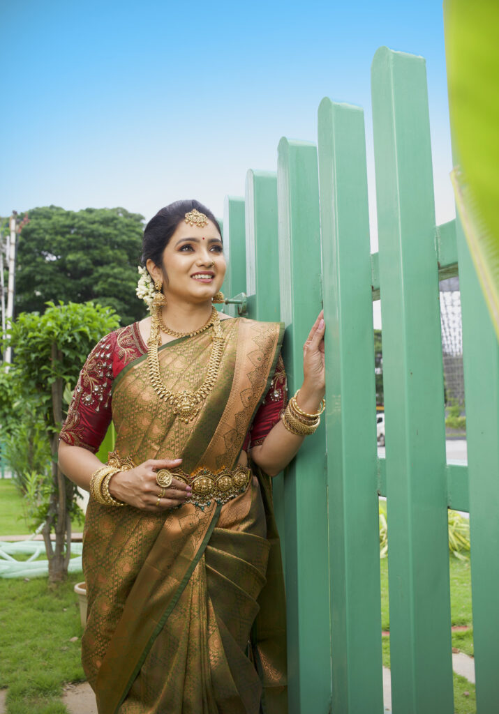 Bride with green silk saree and gold jewelry, make up by Lara Styles Salon Coimbatore