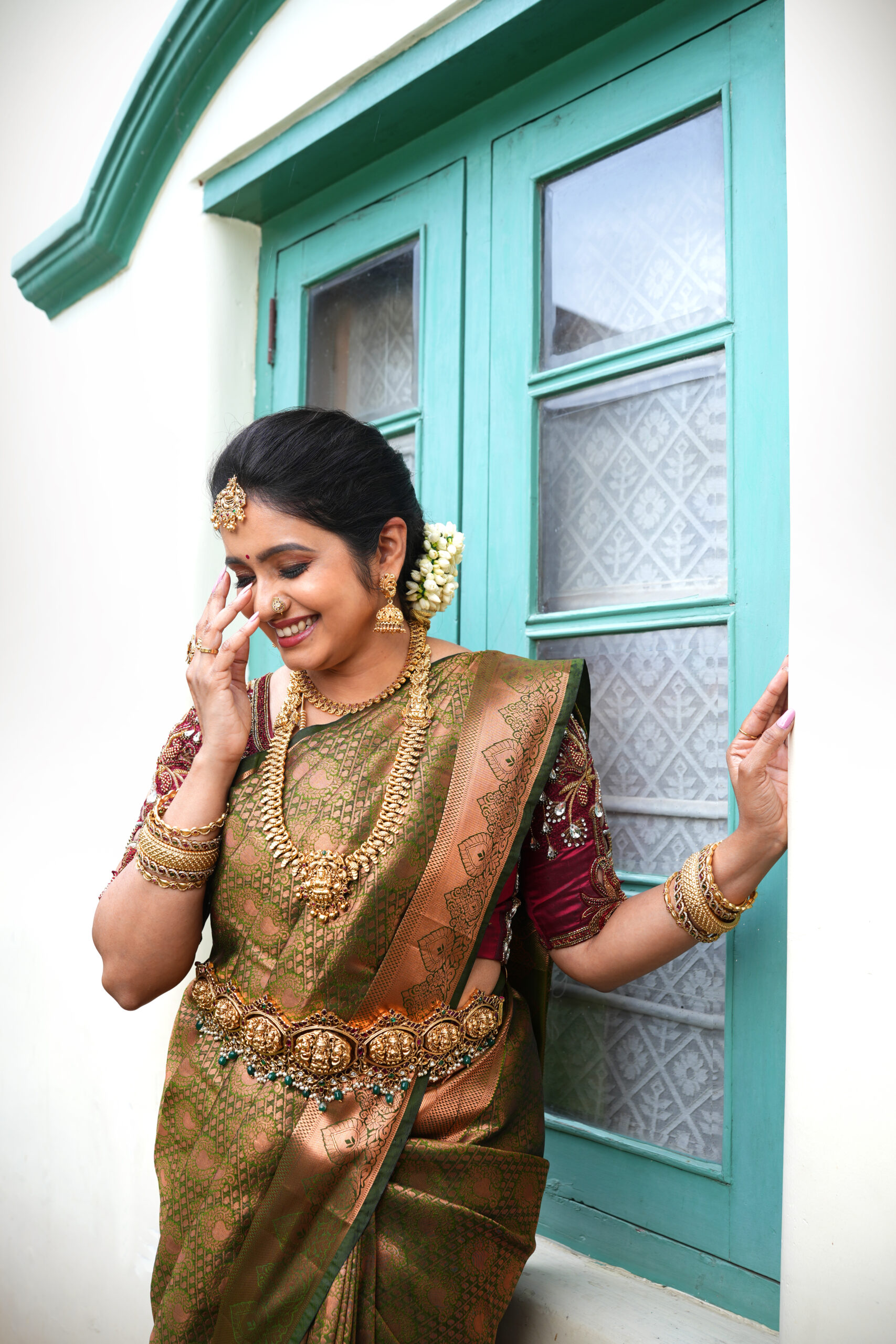 Bridal hairdo with floral accessories and makeup by Lara Styles Unisex Salon Coimbatore