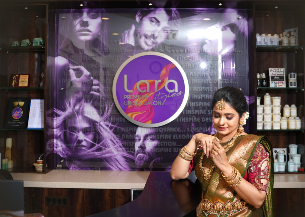 South Indian bride with gold necklace and green silk saree, styled by Lara Styles Salon Coimbatore